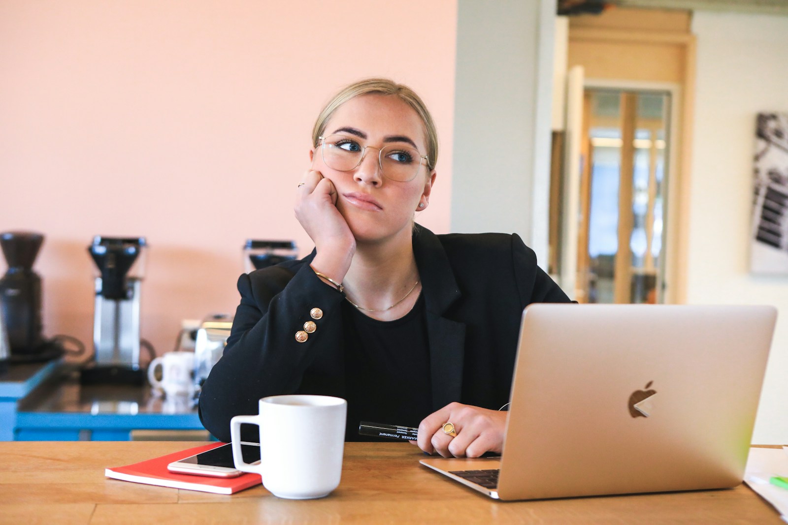 woman in black long sleeve shirt using macbook and thinking "Who Decides How Much My Property Is Worth?"