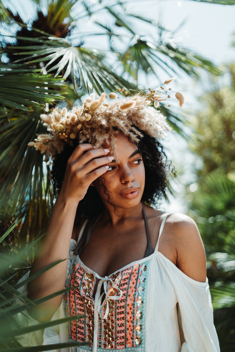 a woman in a white top with a flower crown on her head thinking about The Impact Increased Claims and Payouts Have on Insurance Rates in Florida